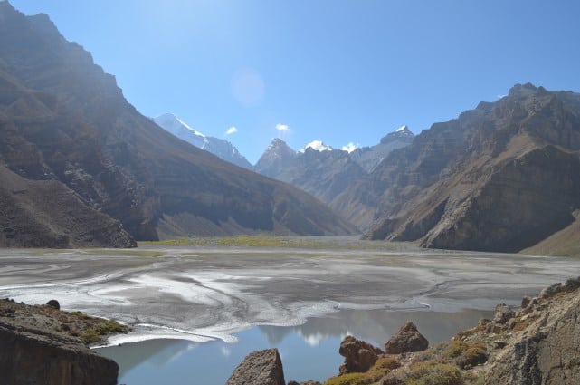 Sopona Lake above Mane village with water and snow peaks of the Manirang range