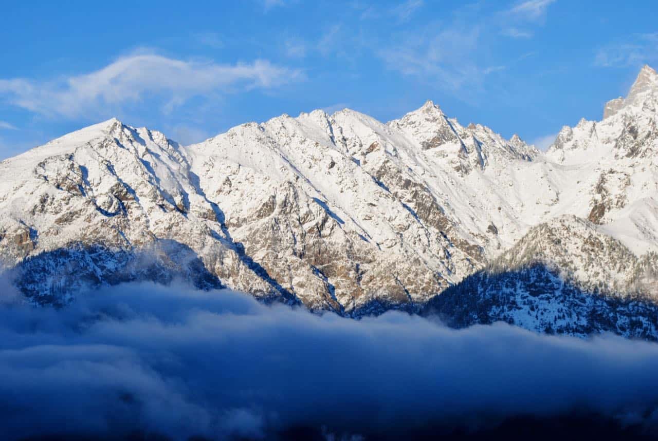 Snow-covered Kinner Kailash range above the clouds seen from Kalpa after fresh snowfall