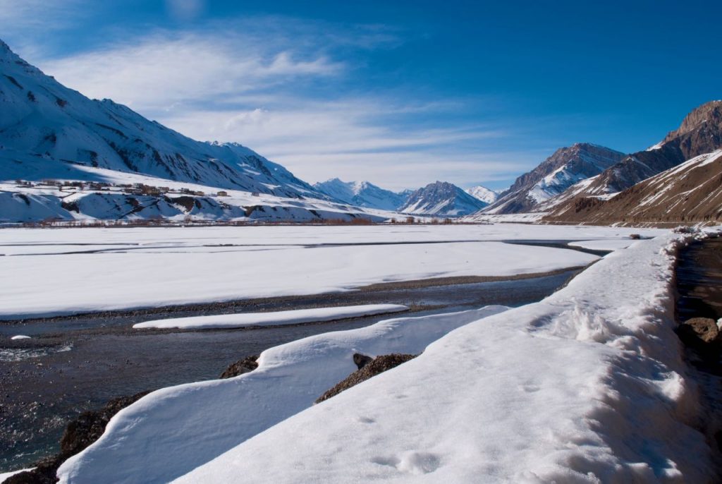 Frozen Spiti river and snowbound slopes during a March winter trip to Spiti Valley