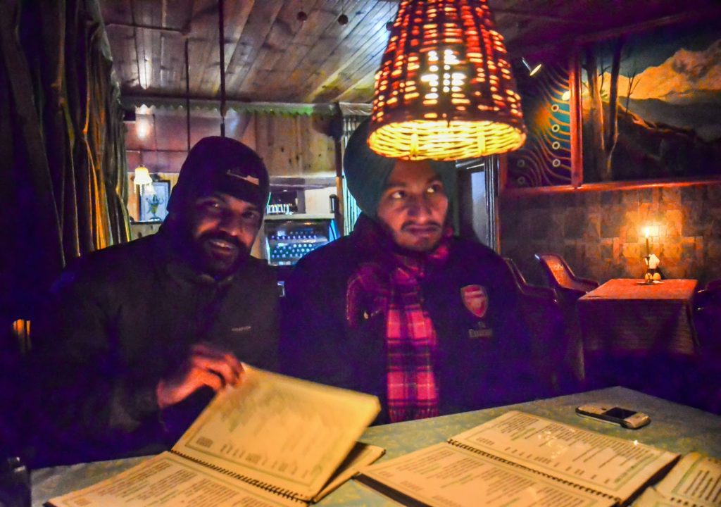 Checking the menu at Evergreen Restaurant in Kasol