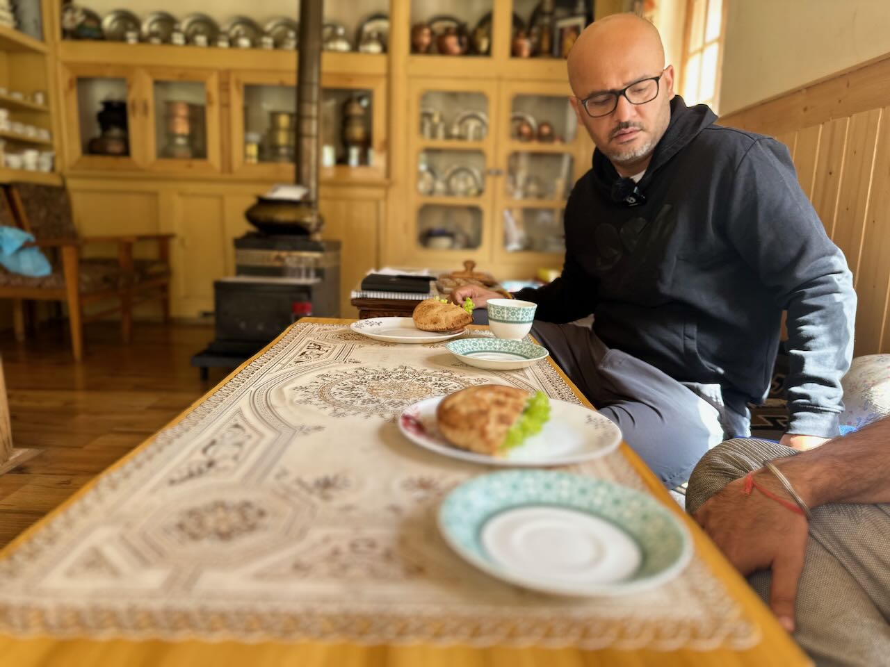 Eating traditional Ladakhi food including khambir bread, momos and apricot jam at a homestay