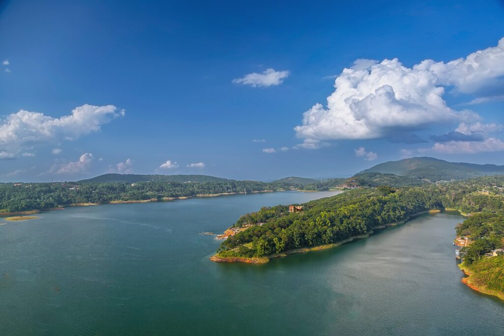 Umiam Lake reservoir surrounded by pine-covered hills on the Guwahati - Shillong road
