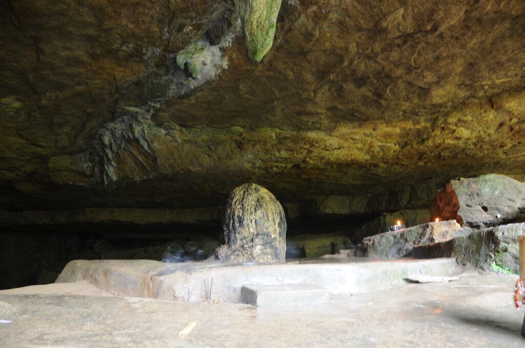 Large stalagmite under the rock roof of Mawjymbuin Cave in Mawsynram