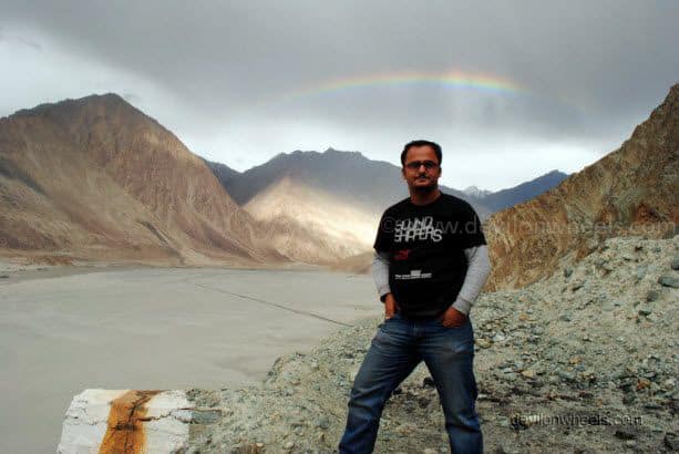 Dheeraj Sharma with rainbow on the road to Nubra Valley from Khardung La in Leh - Ladakh